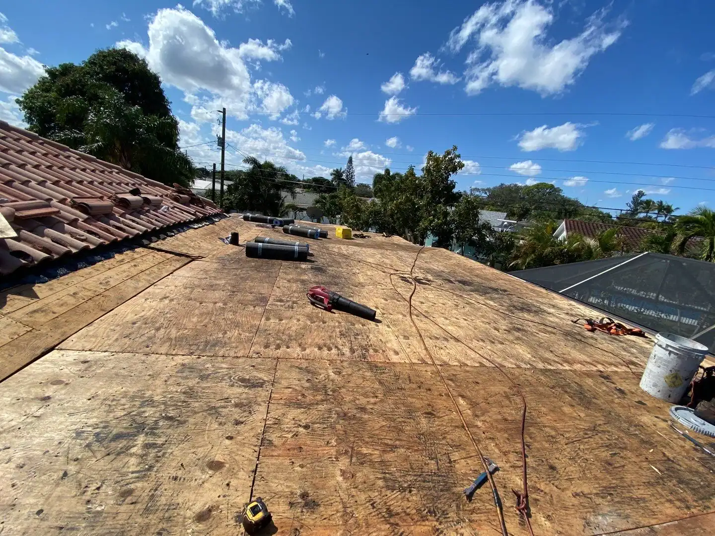 New roofing installation in progress with plywood sheathing ready for new shingles or roofing material in Broward County, FL