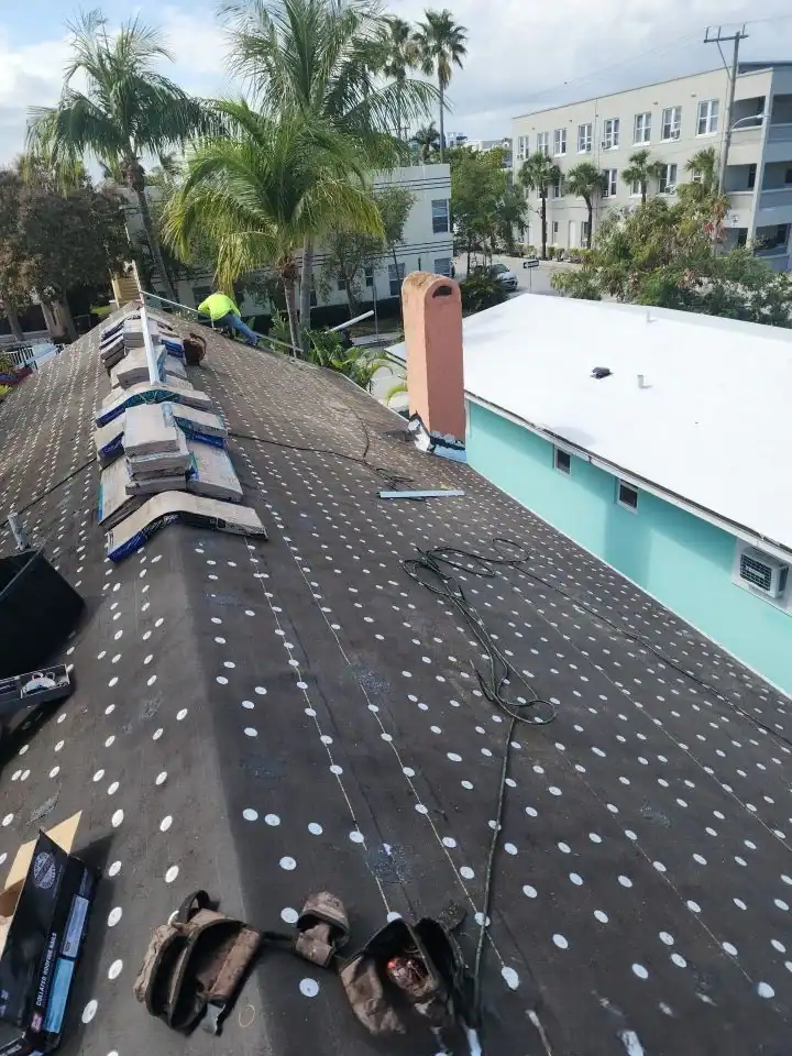 New roofing installation by Aastro Roofing in a residential area with palm trees.